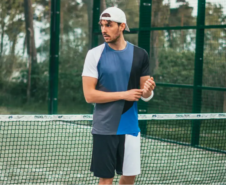 A man holding a tennis racket on the court