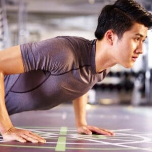 A man is doing push ups in the gym