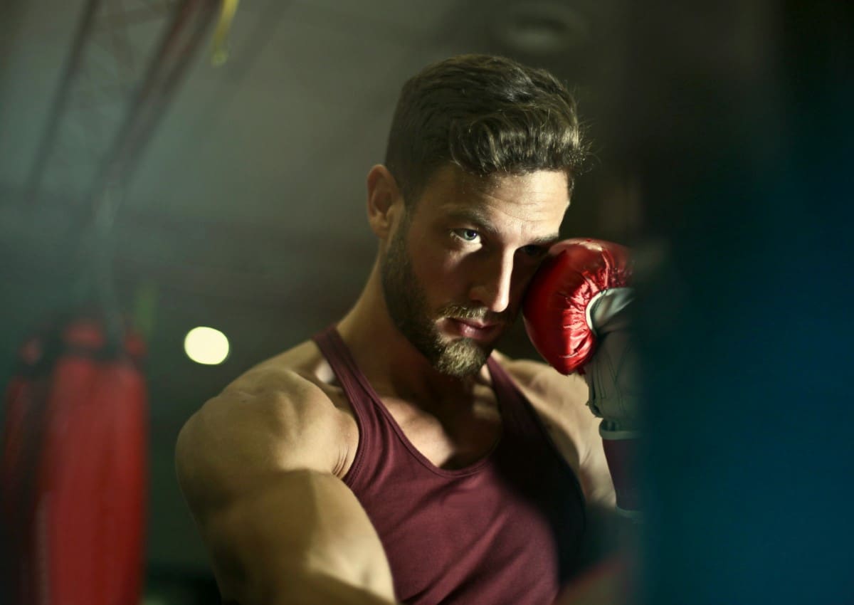 A man holding a boxing glove in his hand.